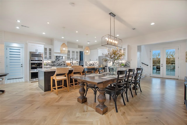 dining space with recessed lighting, french doors, and visible vents