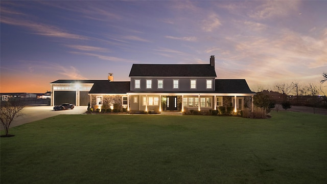 view of front of property with stone siding, concrete driveway, a chimney, and a lawn
