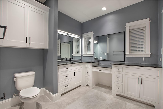 bathroom featuring a shower stall, a spacious closet, toilet, and baseboards