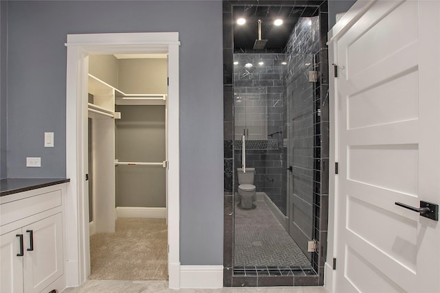 laundry room with baseboards, light tile patterned floors, a sink, washing machine and clothes dryer, and cabinet space