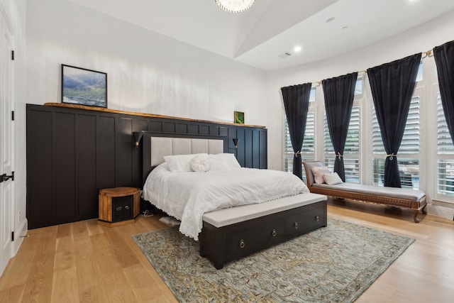 bedroom featuring lofted ceiling, recessed lighting, and light wood-type flooring