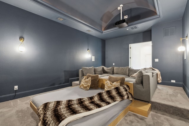 home theater featuring a tray ceiling, carpet flooring, baseboards, and visible vents