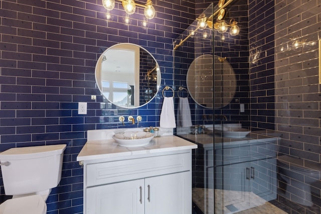 full bathroom with toilet, tile walls, a stall shower, and vanity