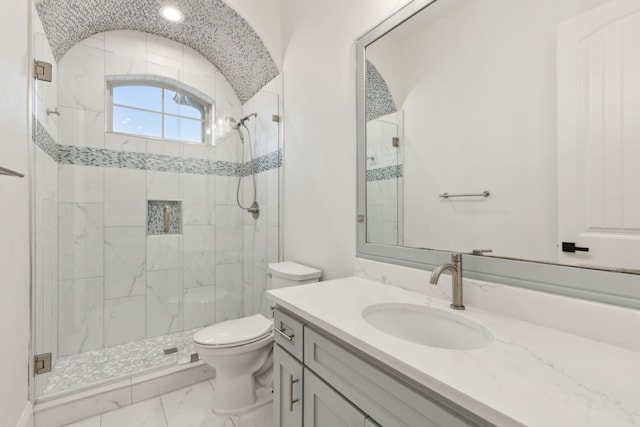 full bathroom with vanity, toilet, a stall shower, and marble finish floor