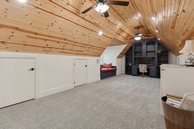 additional living space with built in shelves, baseboards, lofted ceiling, wood ceiling, and light colored carpet