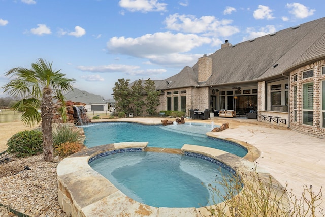 view of swimming pool featuring a patio and a pool with connected hot tub