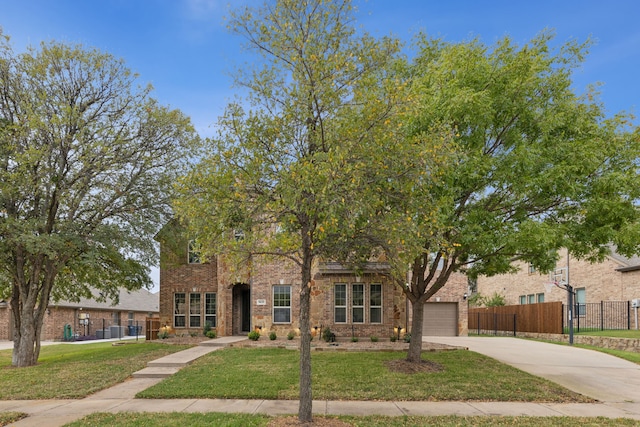 view of front of home with driveway, brick siding, fence, and a front yard