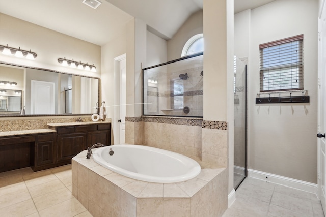 full bathroom featuring tile patterned floors, a tile shower, vanity, and a bath