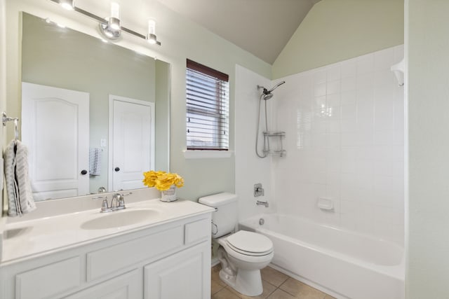 bathroom featuring toilet, tub / shower combination, vaulted ceiling, vanity, and tile patterned flooring