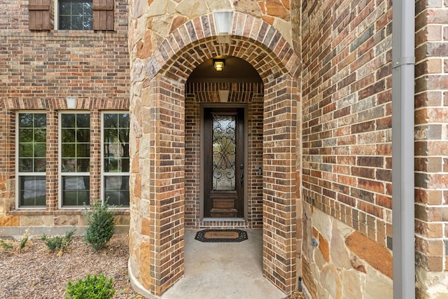 property entrance featuring brick siding