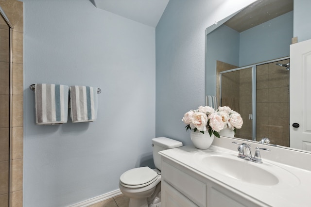 full bathroom featuring vanity, a shower stall, toilet, and tile patterned floors