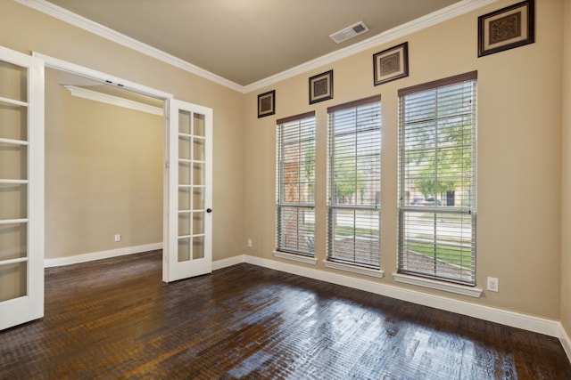 empty room featuring french doors, visible vents, ornamental molding, wood finished floors, and baseboards