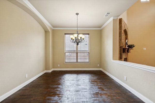 spare room with baseboards, crown molding, visible vents, and an inviting chandelier