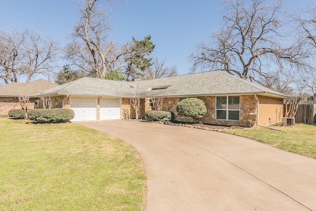 single story home featuring a garage, concrete driveway, a front lawn, and central AC unit