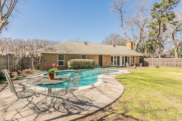 view of swimming pool featuring a patio, a lawn, a fenced backyard, and a fenced in pool