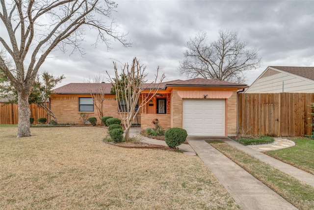 ranch-style house featuring brick siding, fence, and an attached garage