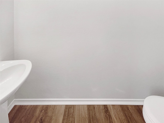 bathroom featuring wood finished floors and baseboards