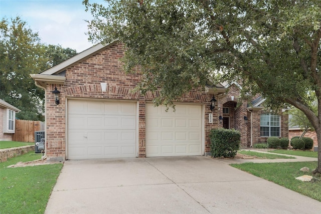 view of front of home featuring driveway, a garage, fence, and brick siding