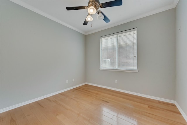 spare room with baseboards, a ceiling fan, light wood-style flooring, and crown molding