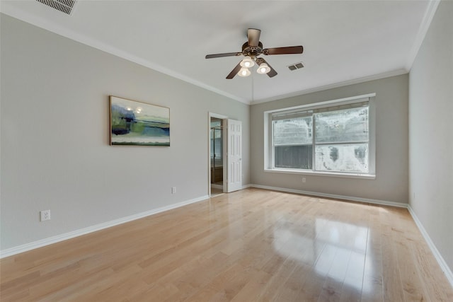 unfurnished room featuring visible vents, crown molding, light wood-style flooring, and baseboards