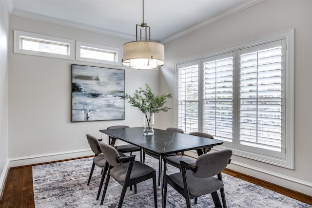 dining area featuring a wealth of natural light, crown molding, and wood finished floors