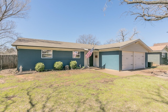 ranch-style house with driveway, an attached garage, fence, and a front yard