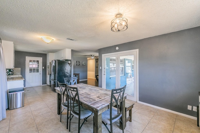 dining room featuring french doors, visible vents, baseboards, and light tile patterned flooring