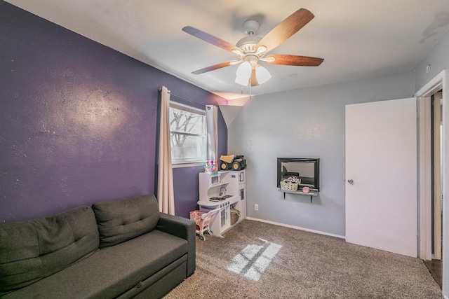 sitting room with ceiling fan, baseboards, and carpet flooring