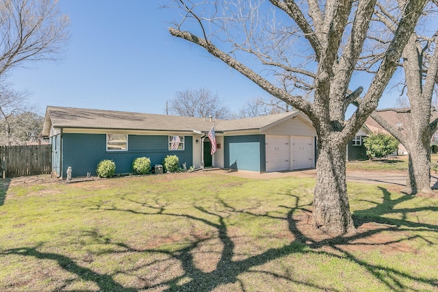 view of front facade with a garage, driveway, fence, and a front yard