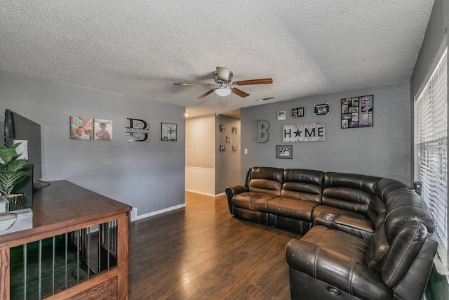 living area with baseboards, visible vents, a ceiling fan, wood finished floors, and a textured ceiling