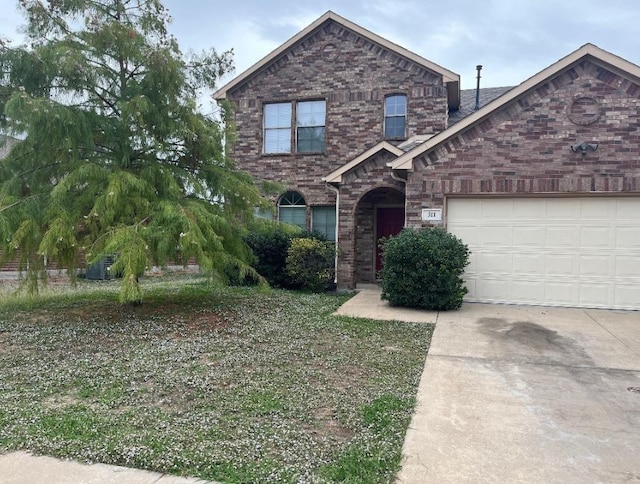 traditional-style home with an attached garage, concrete driveway, and brick siding