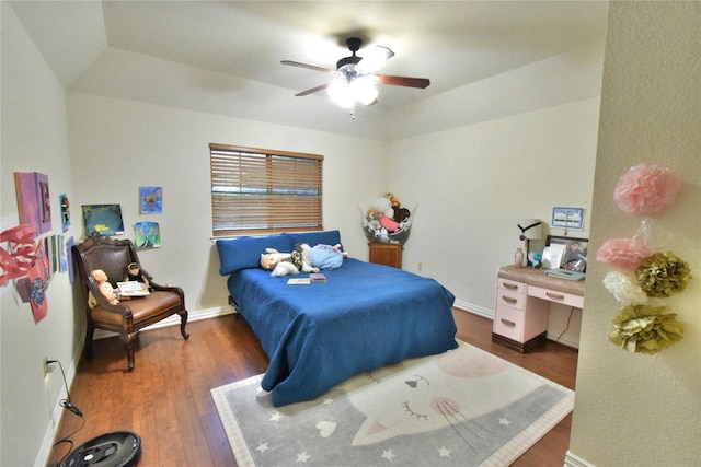 bedroom featuring a ceiling fan, baseboards, and wood finished floors