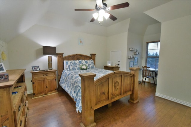 bedroom with lofted ceiling, wood-type flooring, and baseboards