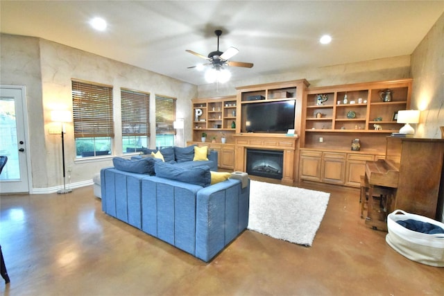 living room featuring a fireplace, recessed lighting, ceiling fan, concrete floors, and baseboards