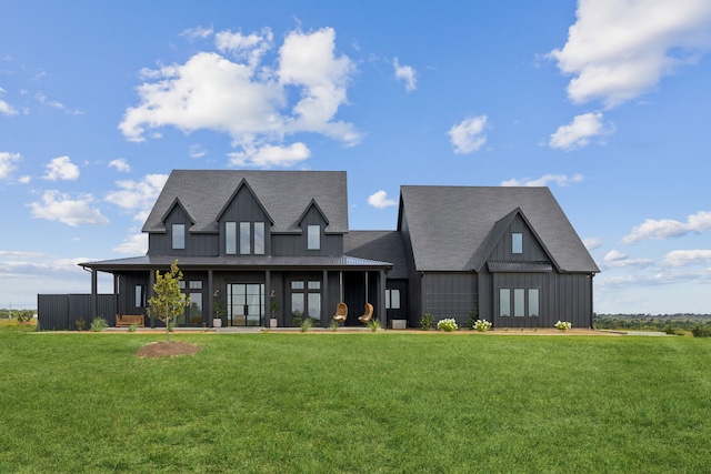 modern inspired farmhouse with roof with shingles, board and batten siding, and a front yard