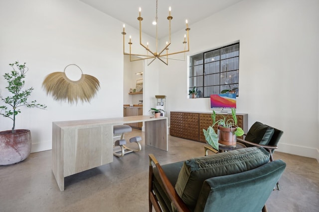 dining room featuring a notable chandelier, concrete floors, a towering ceiling, and baseboards