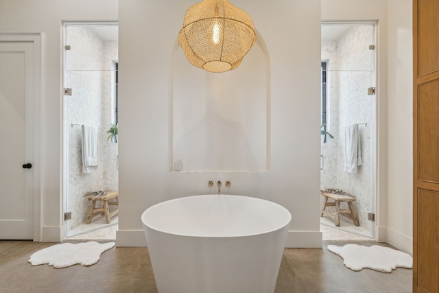 full bath featuring a stall shower and a soaking tub