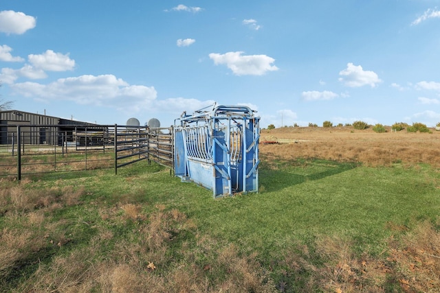 view of outbuilding with a rural view, an exterior structure, and an outdoor structure