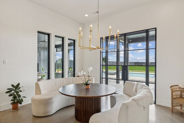 dining room with recessed lighting, a notable chandelier, finished concrete flooring, and baseboards