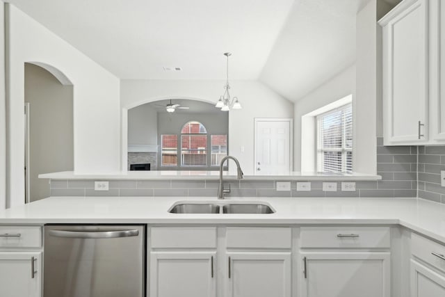 kitchen featuring a sink, a ceiling fan, white cabinets, decorative backsplash, and dishwasher