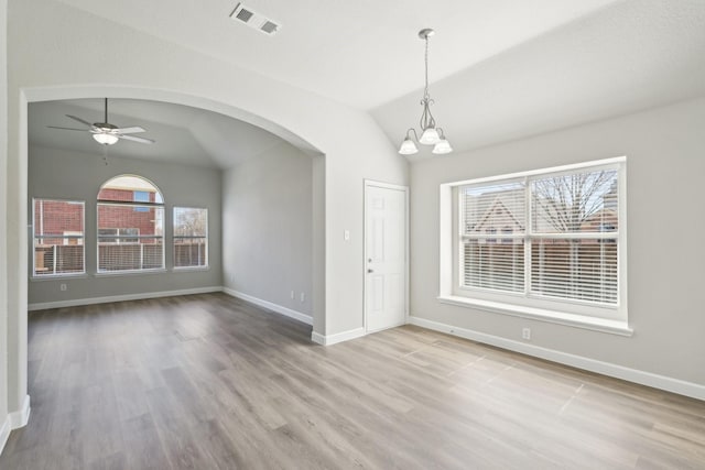 interior space with arched walkways, visible vents, plenty of natural light, and lofted ceiling