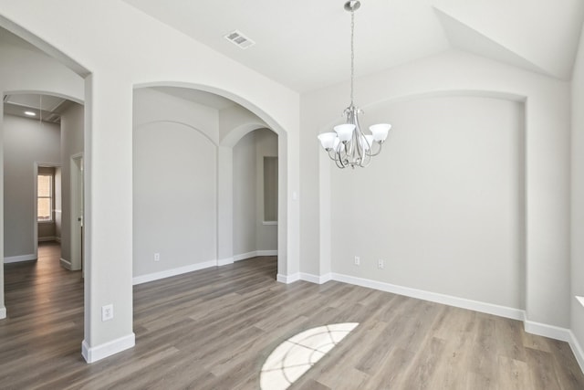 unfurnished room featuring visible vents, baseboards, and wood finished floors