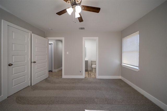 unfurnished bedroom featuring baseboards, visible vents, a ceiling fan, connected bathroom, and carpet flooring