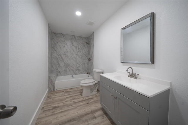 full bathroom with shower / bathing tub combination, toilet, vanity, wood finished floors, and baseboards