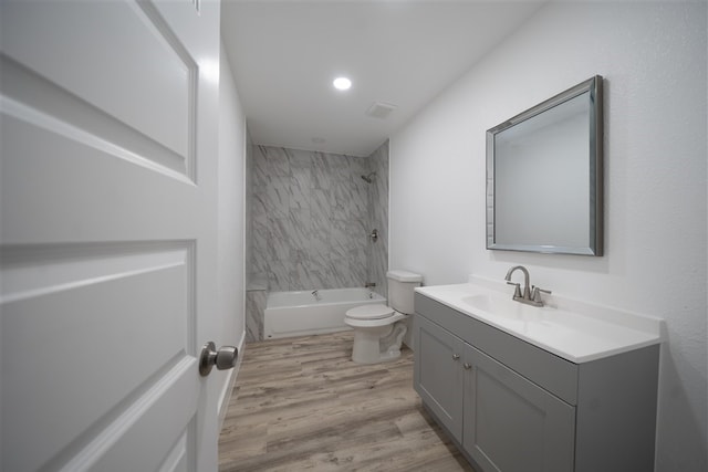 full bath featuring visible vents, toilet, wood finished floors, tub / shower combination, and vanity