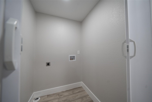 laundry area with hookup for a washing machine, light wood-style flooring, laundry area, baseboards, and electric dryer hookup