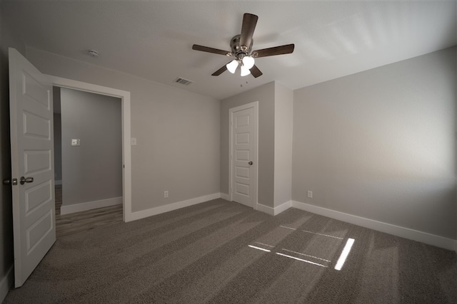 unfurnished bedroom featuring carpet, baseboards, and visible vents