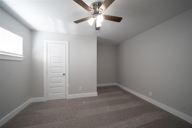 unfurnished room with a ceiling fan, carpet, and baseboards