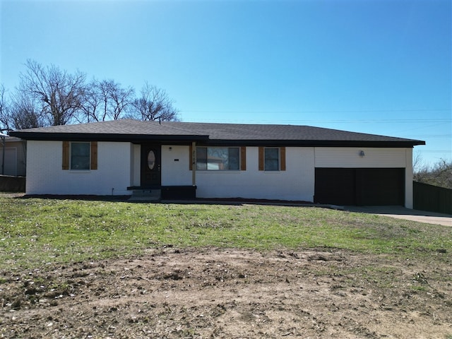 ranch-style home featuring a garage, driveway, a front lawn, and brick siding