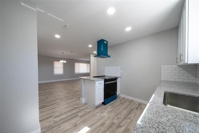 kitchen featuring decorative backsplash, white cabinetry, island exhaust hood, and electric range oven